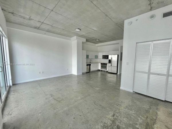 Unit with open concept layout loft style, 10ft ceilings, concrete floor, impact glass and stainless steel appliances.
